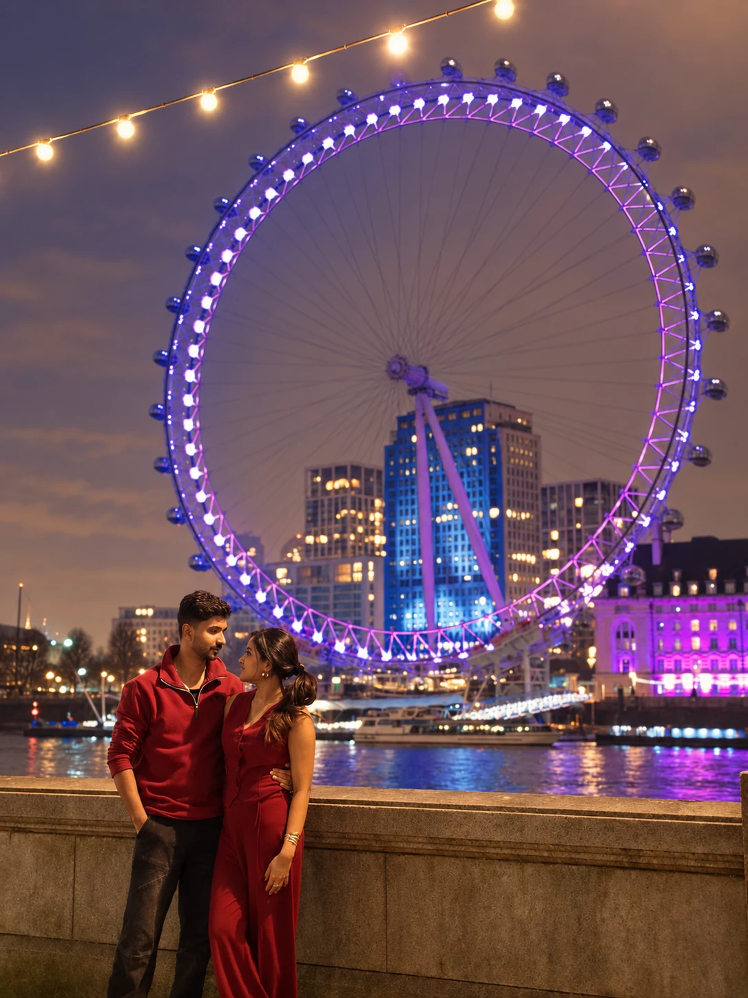 Ronn and Anna looking at each other beside the illuminated London Eye
